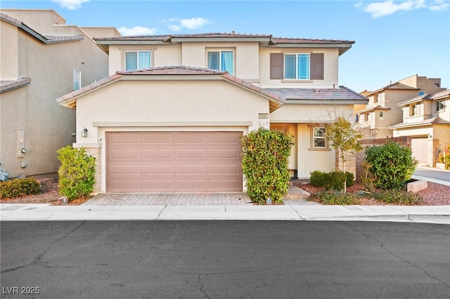 view of front of house with a residential view, a tiled roof, an attached garage, decorative driveway, and stucco siding