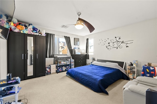 bedroom with carpet floors, visible vents, and a ceiling fan