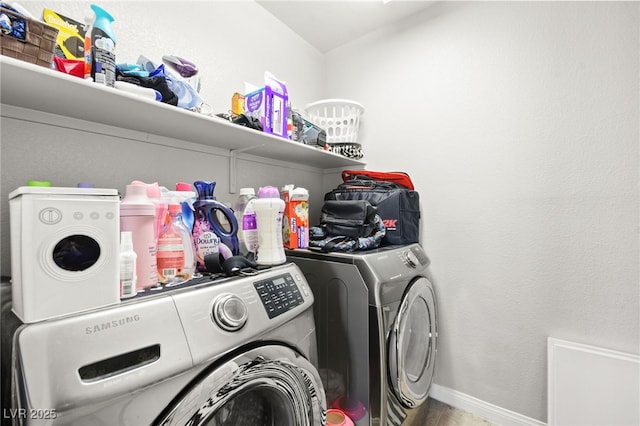 laundry room with laundry area, washer and clothes dryer, and baseboards