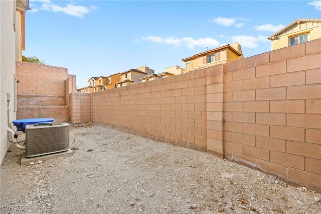 view of yard with a fenced backyard and central air condition unit