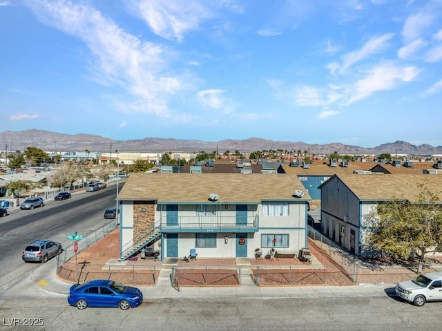 multi unit property with stairs, a residential view, a balcony, and a mountain view