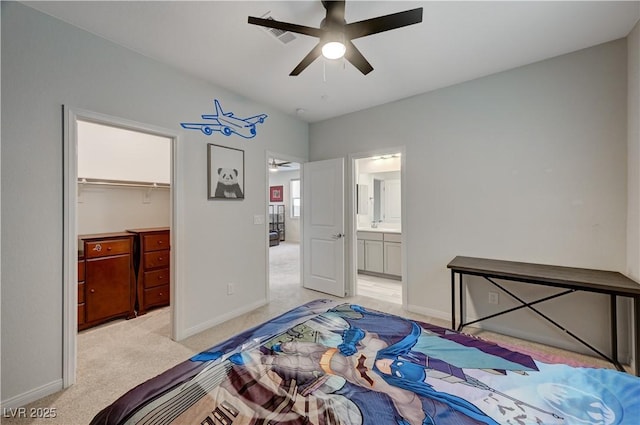 bedroom with light carpet, a spacious closet, baseboards, and a closet