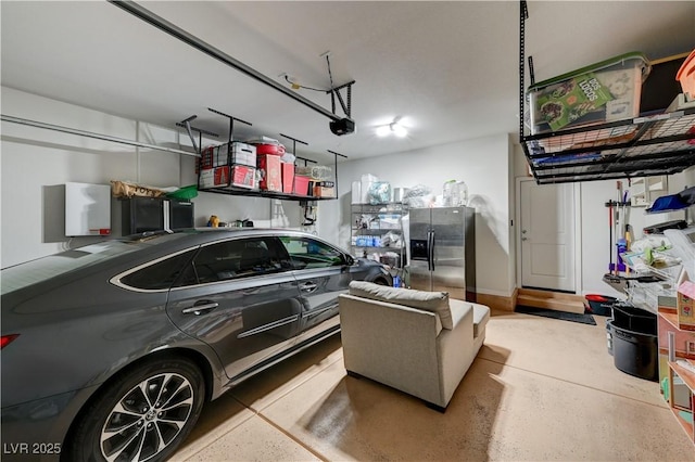 garage with a garage door opener and stainless steel fridge with ice dispenser