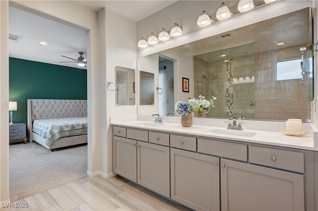 ensuite bathroom featuring a stall shower, visible vents, a sink, and ensuite bathroom