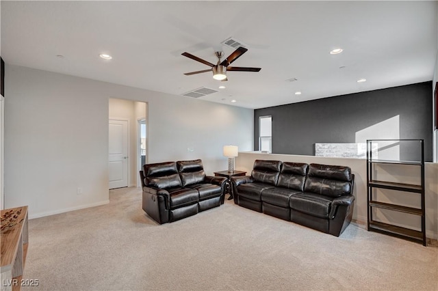 living room featuring light colored carpet, visible vents, baseboards, and recessed lighting