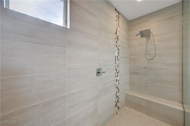 bathroom featuring a tile shower