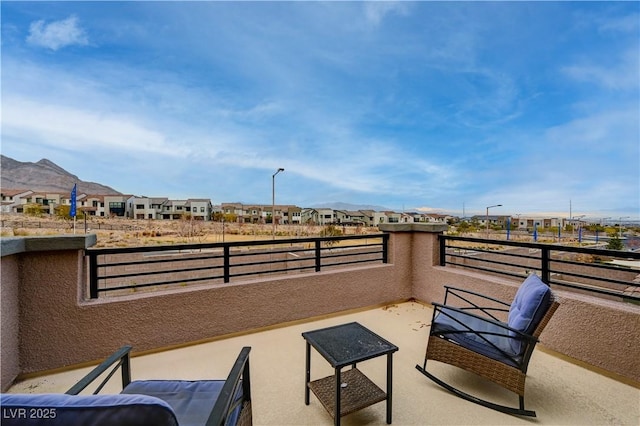 view of patio / terrace with a residential view and a balcony