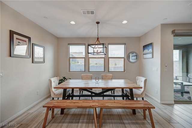 dining room featuring light wood finished floors, baseboards, visible vents, and recessed lighting