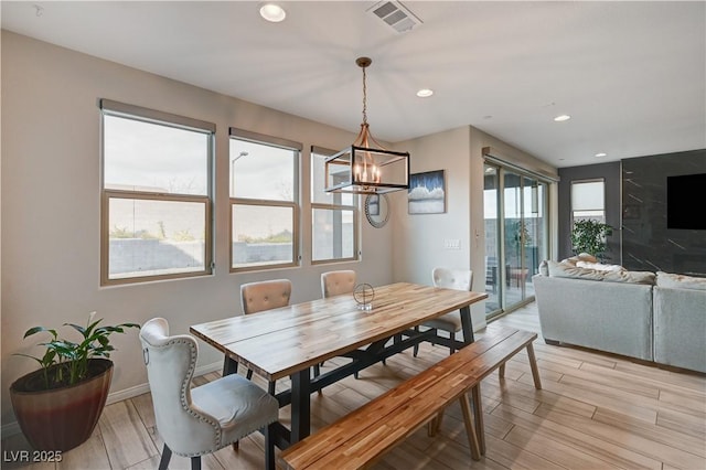 dining room featuring baseboards, light wood-style flooring, visible vents, and recessed lighting