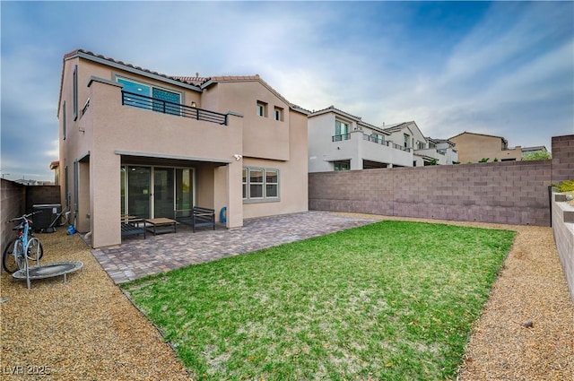 rear view of property featuring a patio area, a fenced backyard, central AC unit, and stucco siding