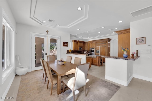 dining area with a tray ceiling, french doors, recessed lighting, visible vents, and baseboards