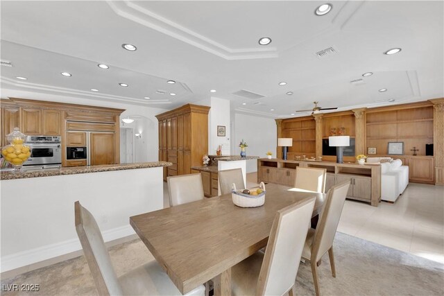 dining area featuring ornamental molding, arched walkways, visible vents, and recessed lighting