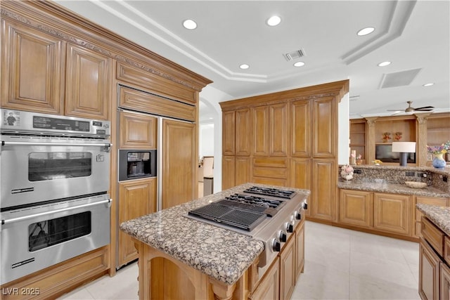 kitchen featuring appliances with stainless steel finishes, recessed lighting, visible vents, and light stone countertops