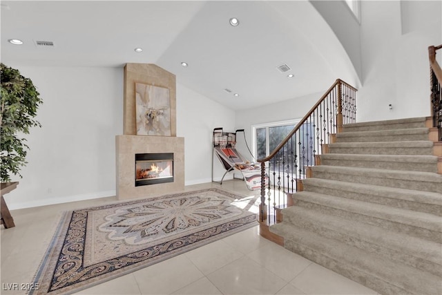 interior space with recessed lighting, tile patterned flooring, visible vents, and a tiled fireplace