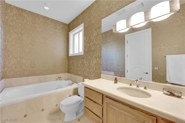 full bath featuring toilet, a garden tub, vanity, and wallpapered walls