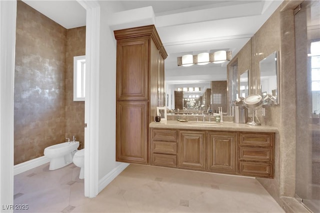 bathroom with baseboards, toilet, tile patterned flooring, vanity, and a bidet