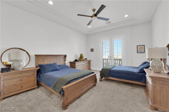 bedroom with recessed lighting, light carpet, visible vents, access to exterior, and a tray ceiling