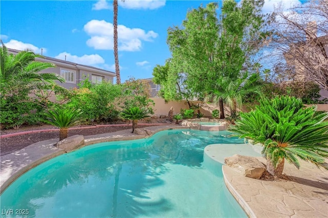 view of pool with fence, a fenced in pool, and an in ground hot tub