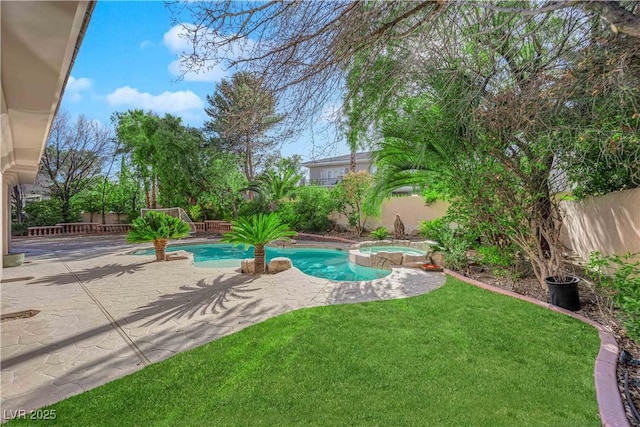 view of pool with a patio, a lawn, a fenced backyard, and a pool with connected hot tub