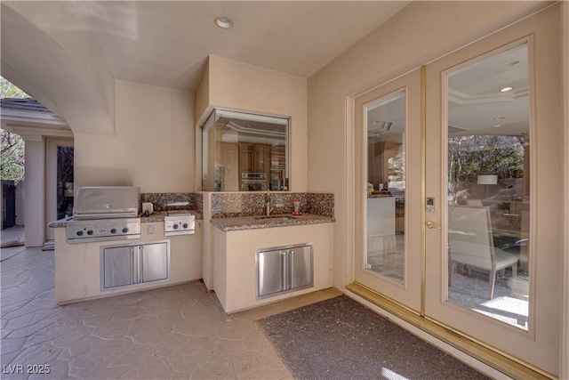 view of patio / terrace featuring exterior kitchen, grilling area, a sink, and french doors