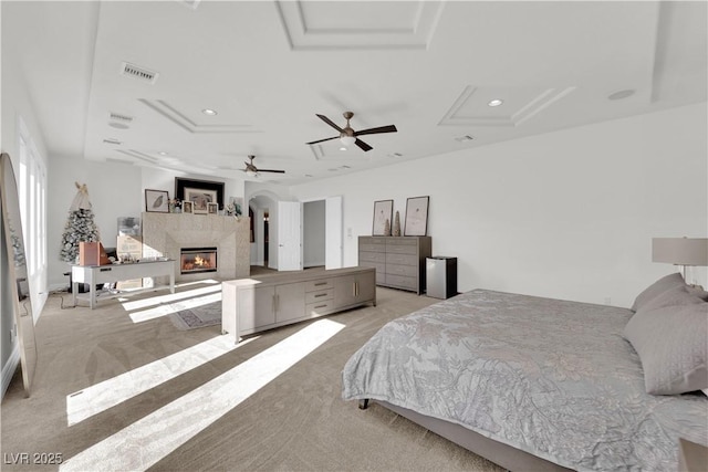 bedroom featuring a fireplace, recessed lighting, visible vents, a ceiling fan, and light carpet