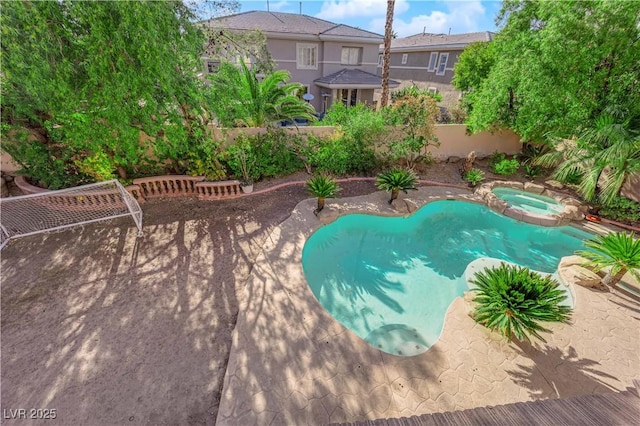 view of pool with a patio and a pool with connected hot tub