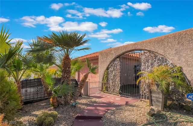 view of gate with a fenced front yard