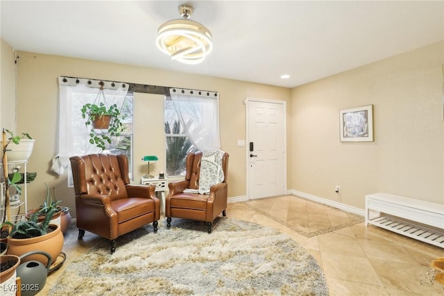 sitting room with tile patterned flooring and baseboards