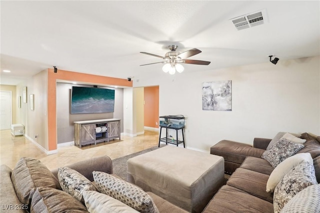 living area featuring ceiling fan, visible vents, and baseboards