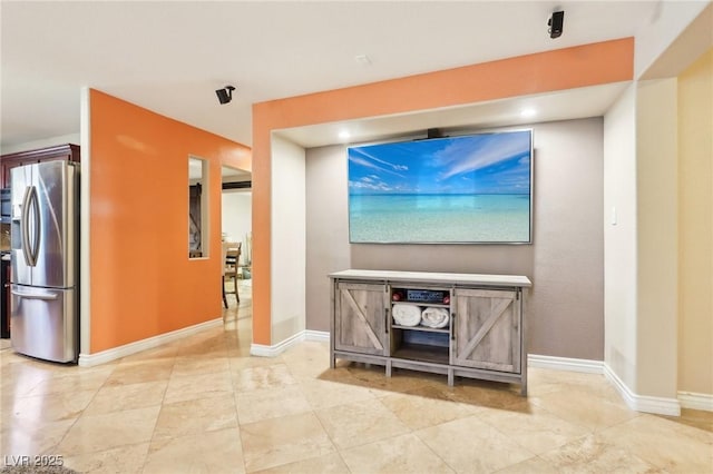 living area featuring baseboards