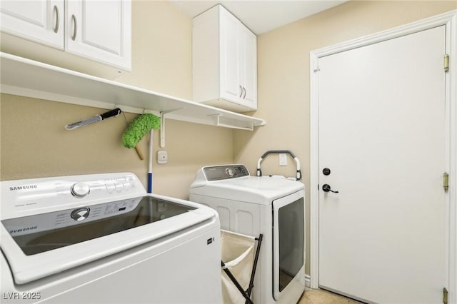 laundry room with independent washer and dryer and cabinet space