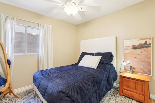 bedroom with baseboards and a ceiling fan