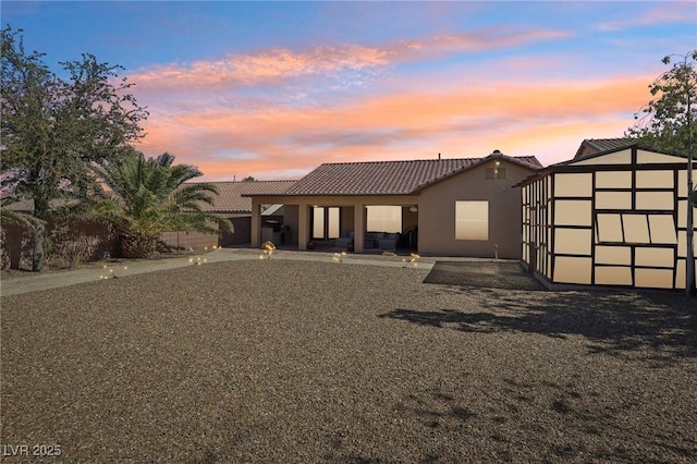 view of front of property featuring a tiled roof and stucco siding