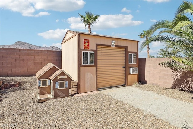 view of outdoor structure featuring an outbuilding and a fenced backyard