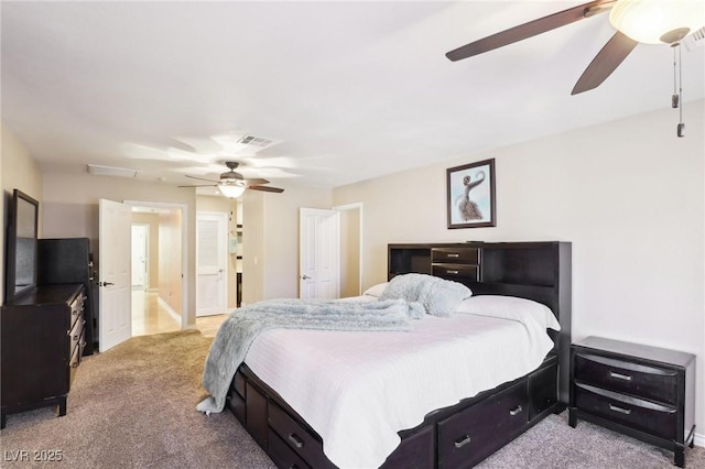 bedroom featuring attic access, visible vents, ceiling fan, and light colored carpet