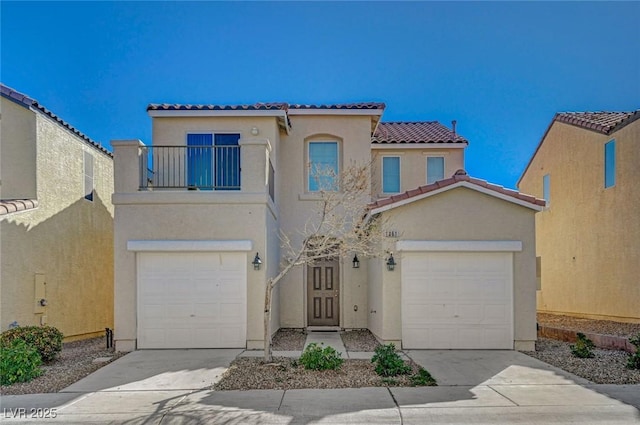 mediterranean / spanish-style home with a tiled roof, driveway, a balcony, and stucco siding