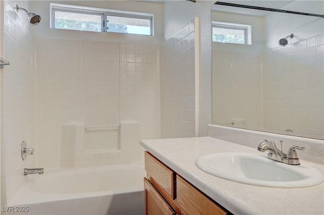 full bath with a wealth of natural light, tub / shower combination, and vanity