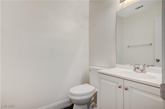 bathroom featuring visible vents, vanity, and toilet