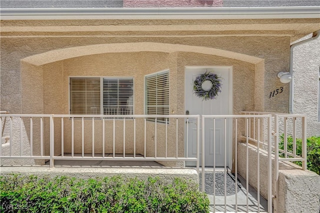 doorway to property featuring stucco siding