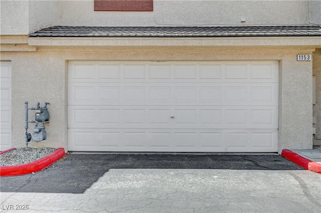 garage featuring aphalt driveway