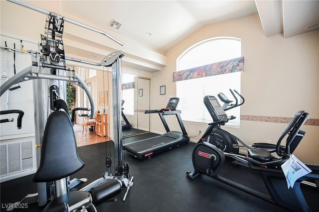 gym featuring vaulted ceiling and visible vents