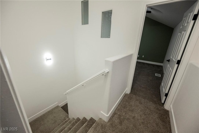 staircase featuring carpet floors, baseboards, and visible vents