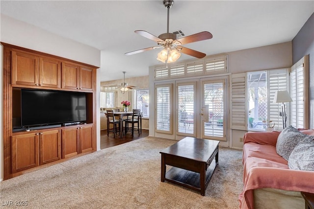 living area featuring ceiling fan, french doors, carpet, and visible vents