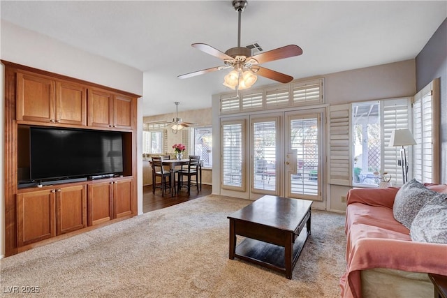 7624 Nocturne Ct, Las Vegas, NV 89128 - living room with a ceiling fan, carpet floors, and healthy amount of natural light
