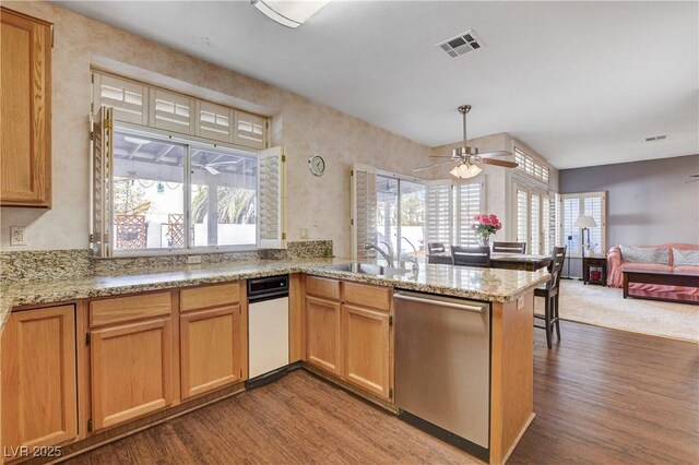 7624 Nocturne Ct, Las Vegas, NV 89128 - kitchen featuring stainless steel dishwasher, wood finished floors, a peninsula, and a ceiling fan