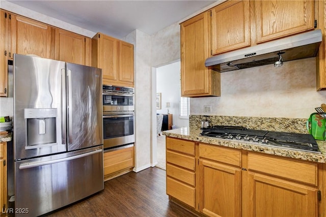 7624 Nocturne Ct, Las Vegas, NV 89128 - kitchen with stainless steel appliances, under cabinet range hood, dark wood-style floors, and light stone counters