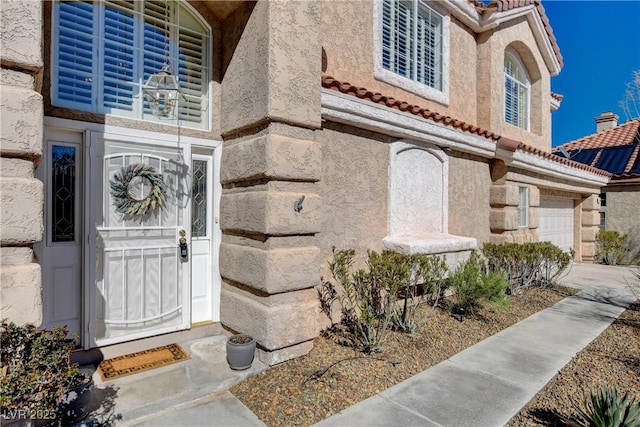 7624 Nocturne Ct, Las Vegas, NV 89128 - doorway to property with an attached garage, stucco siding, and a tile roof