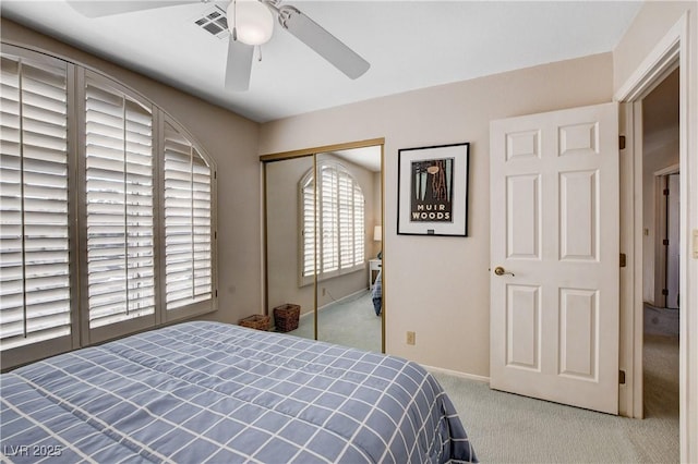 bedroom with light carpet, baseboards, visible vents, a ceiling fan, and a closet