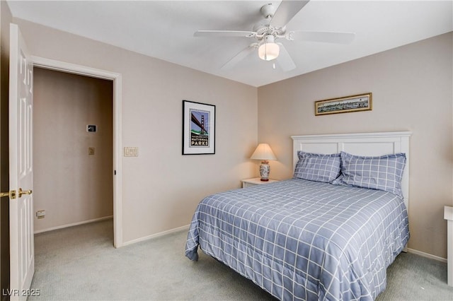 bedroom featuring light carpet, a ceiling fan, and baseboards