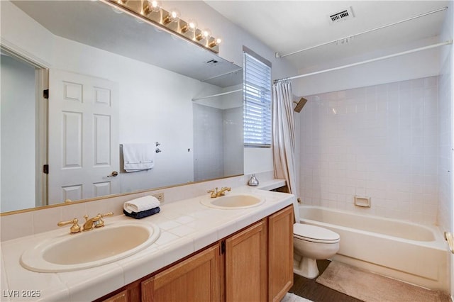 full bath featuring shower / tub combo, visible vents, a sink, and double vanity